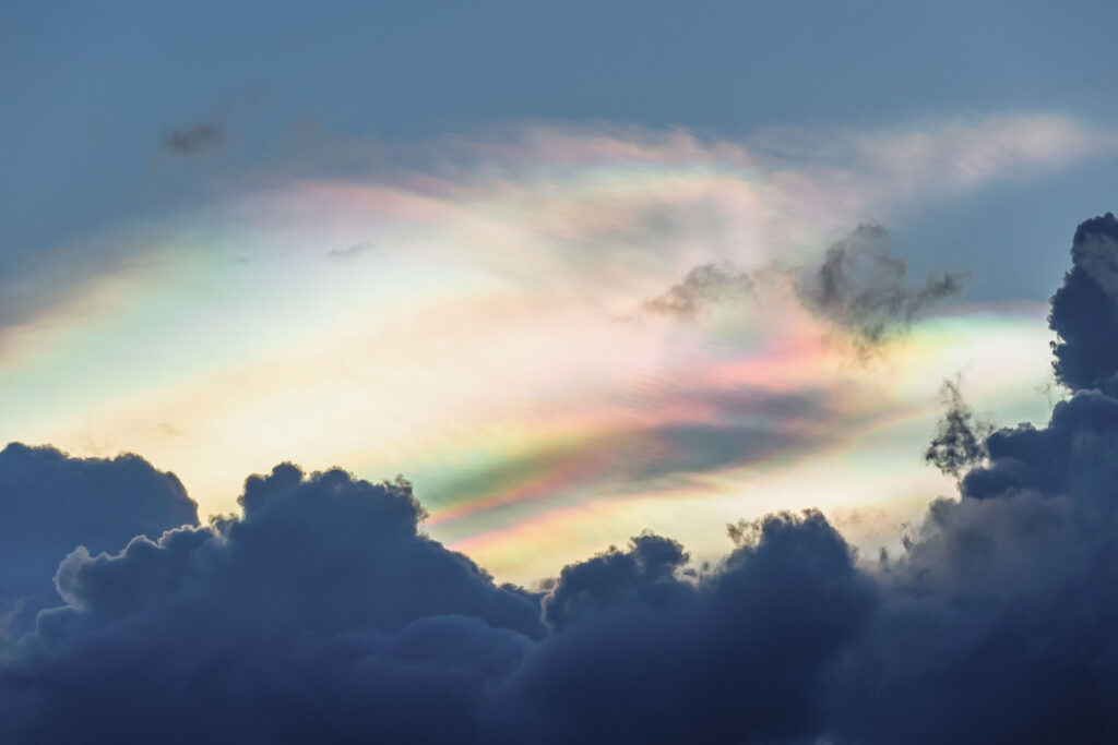 Dramatic iridescent rainbow clouds against a dark sky — unexpected visual inspiration for anyone looking to boost creativity through fresh sensory input